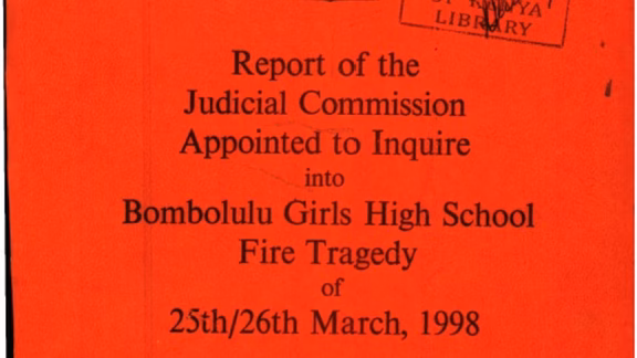 Close-up of the red cover of the 1998 Bombolulu Girls High School Fire tragedy judicial inquiry report.