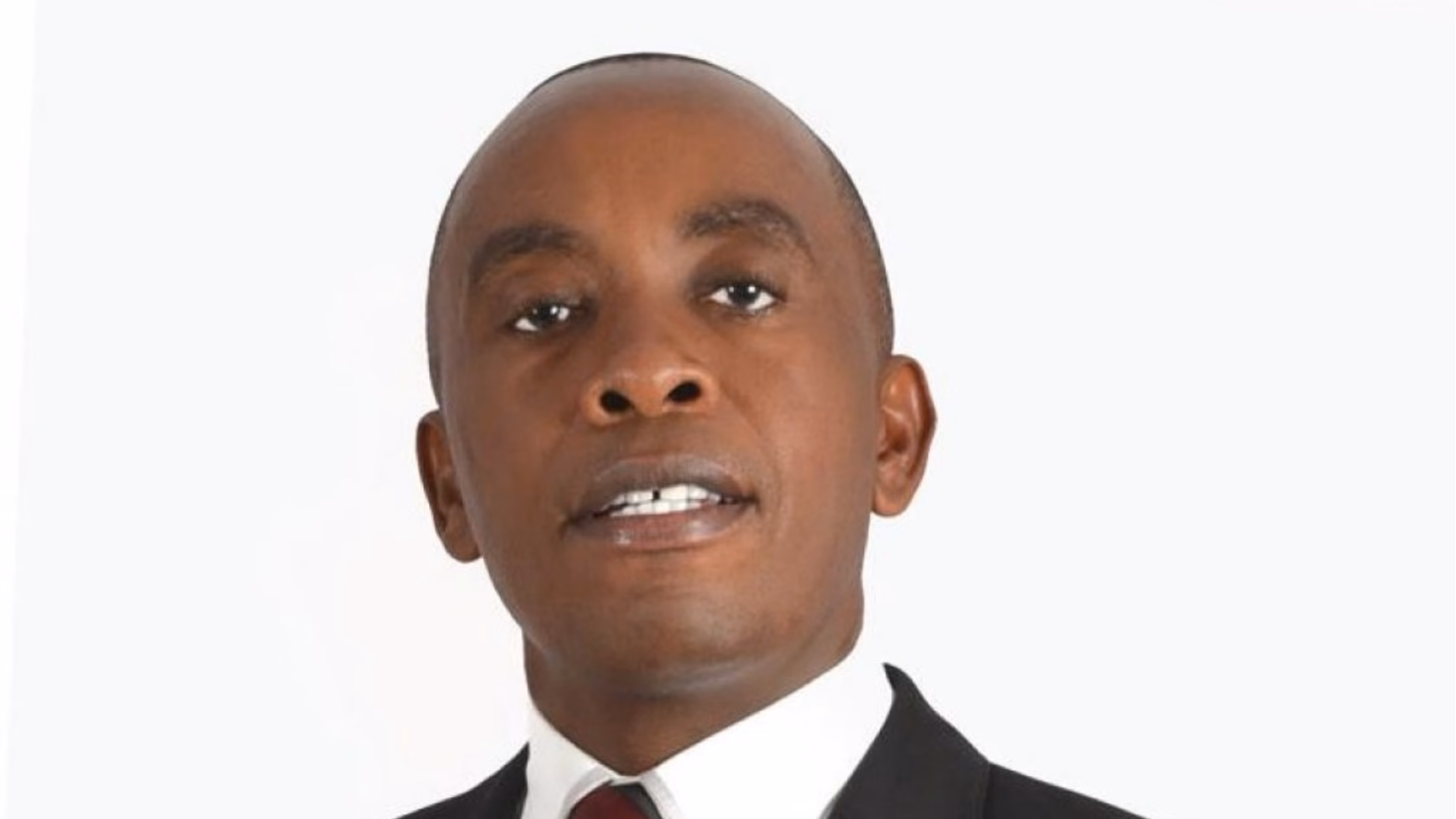 Official studio portrait of Kiambu County Governor Dr. Paul Kimani Wamatangi wearing a dark suit, white shirt, and maroon tie against a plain white background.